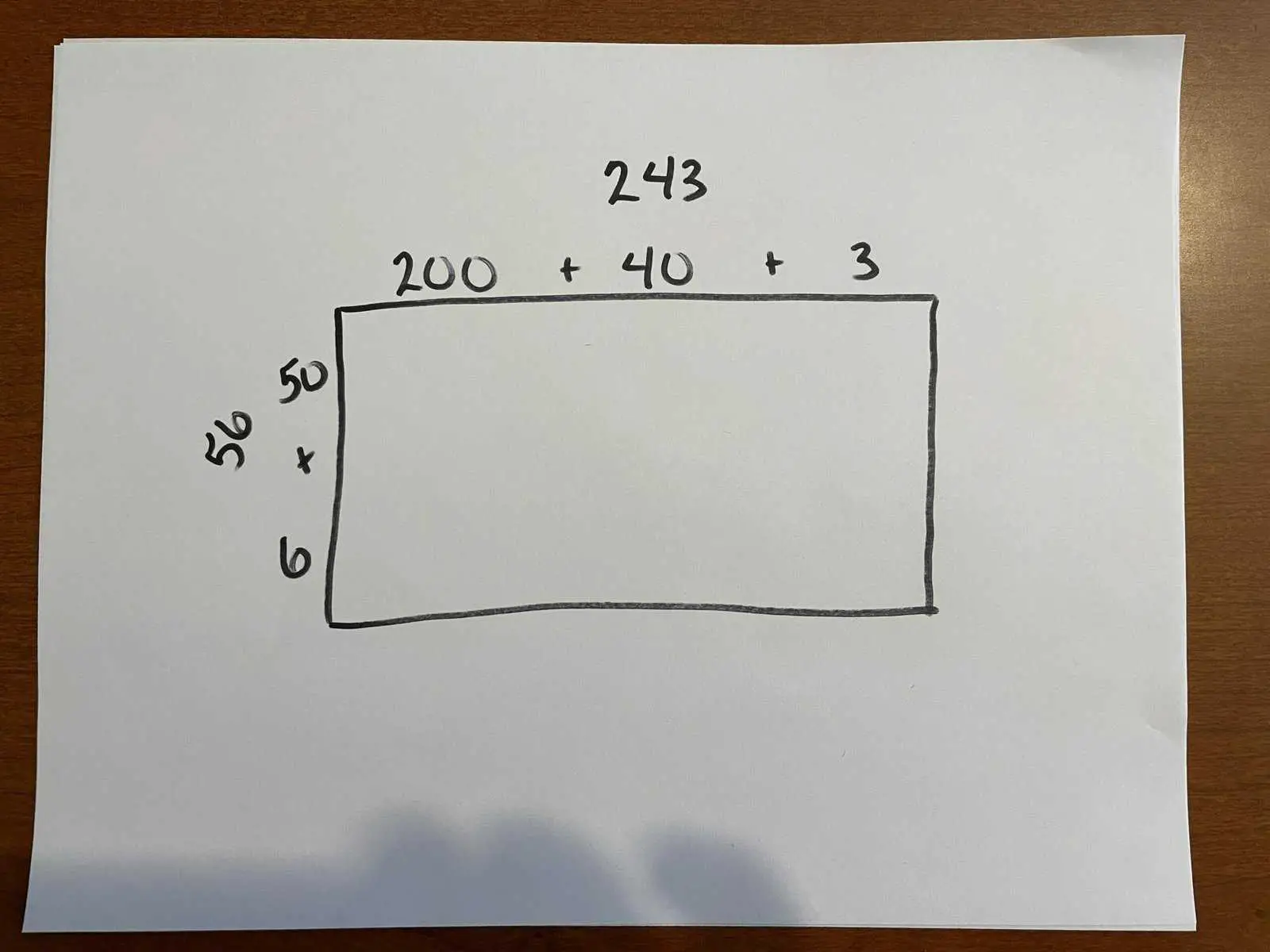 Photo of a hand-drawn rectangle with sides labelled as described in paragraph above.